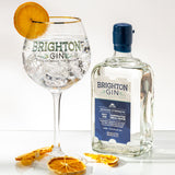Brighton Gin Seaside Strength Gin & Tonic served in a copa glass with ice and a slice of orange
