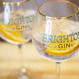 Classic Brighton Gin & Tonics with slice of orange served in copa gin glasses